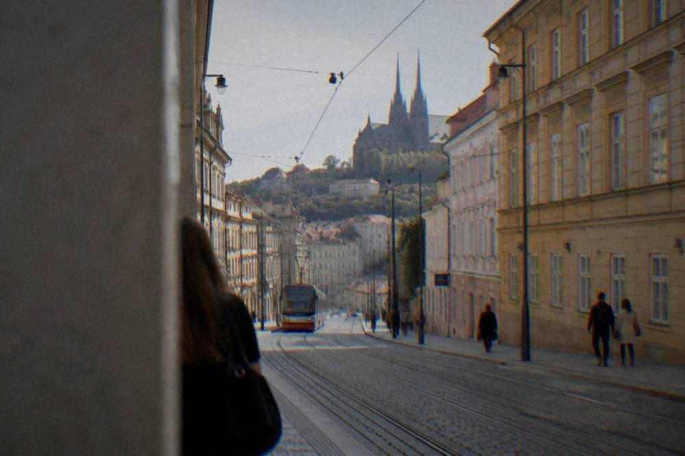 A street in central Brno rising from the station district toward the old town with tram tracks