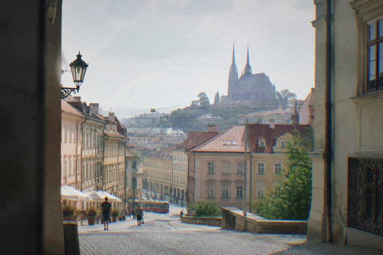 Brno old town rooftops under a mixed sky with the Cathedral of Sts Peter and Paul twin spires on Petrov Hill