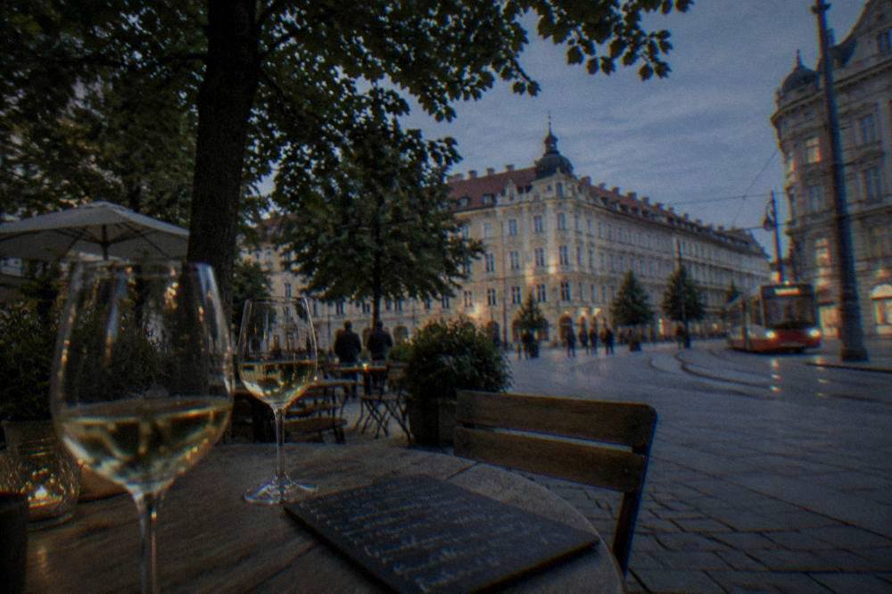 Glasses of white wine on a table beside a slate tile with a handwritten wine list