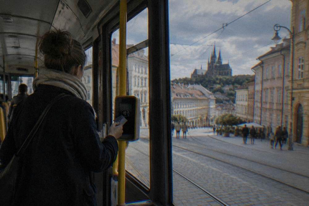 A person paying by contactless card on a Brno tram