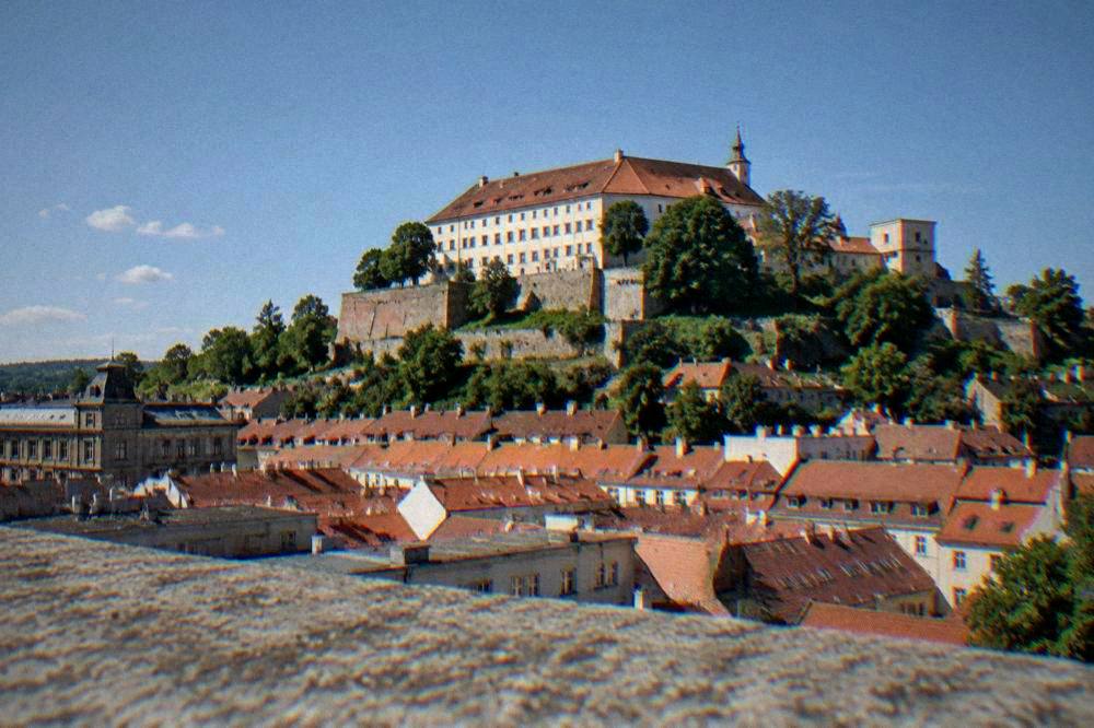 Špilberk Castle standing on its hill above red rooftops under a blue sky