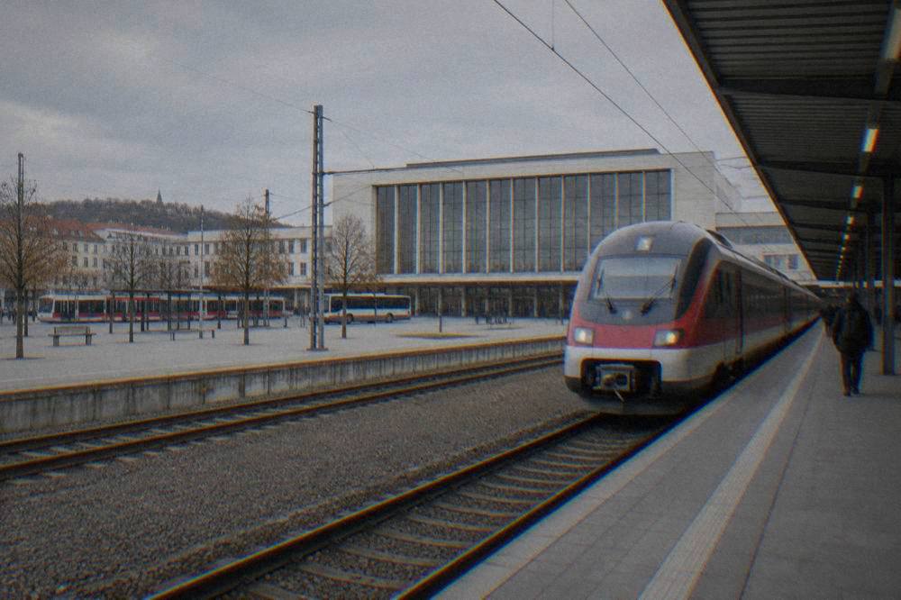 An express train standing at a platform in a Czech railway station