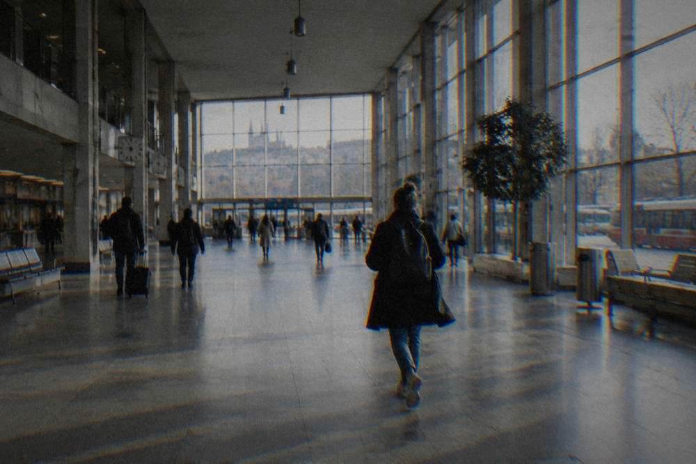 Interior of a modern railway station concourse with departure boards