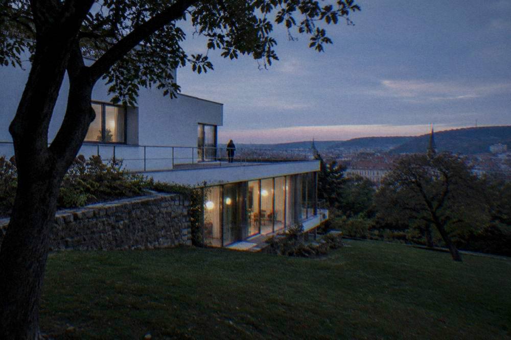 Functionalist white villa with large windows set in a terraced garden