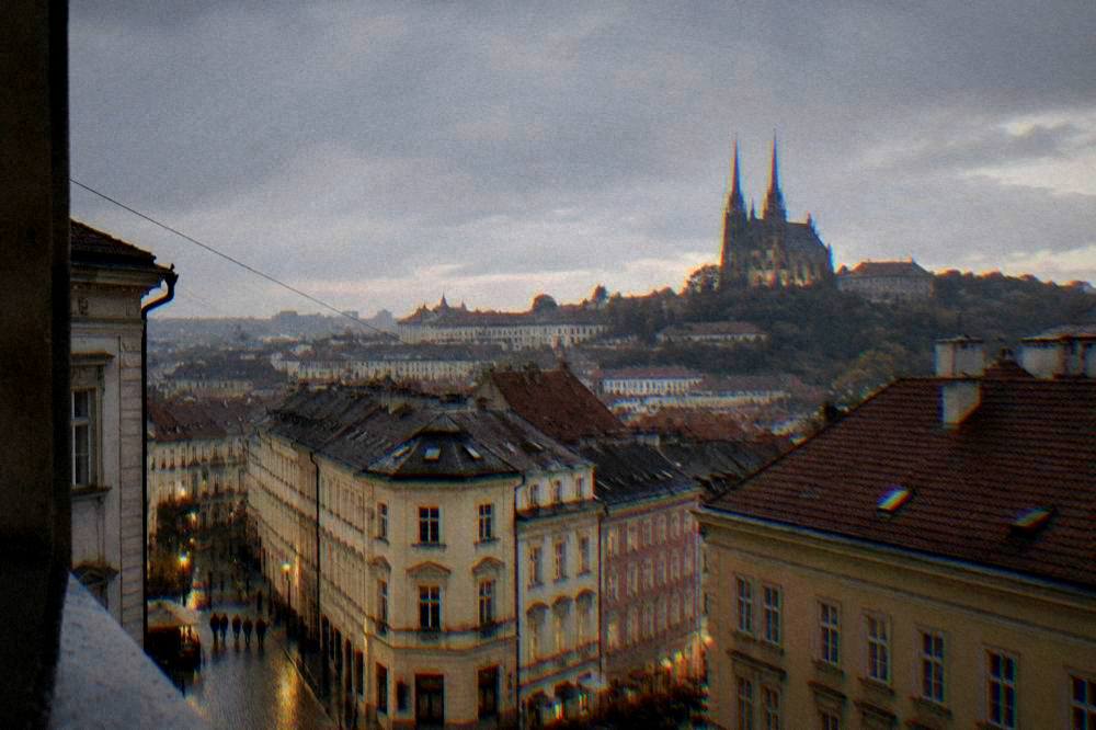Evening view of Brno old town rooftops with cathedral twin spires in the distance