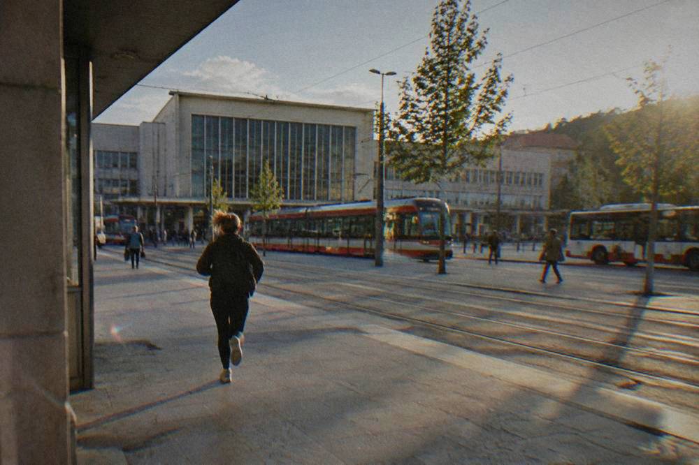 Trams passing outside a city railway station in daylight