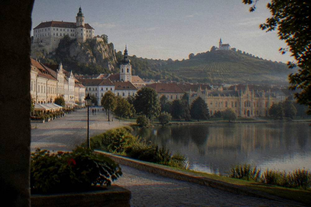 Lednice Chateau seen across its pond at golden hour