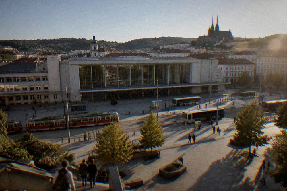 A city square with a cathedral and trees under a clear sky