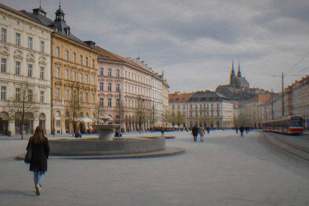 Pastel historic buildings lining Freedom Square in central Brno on a bright afternoon