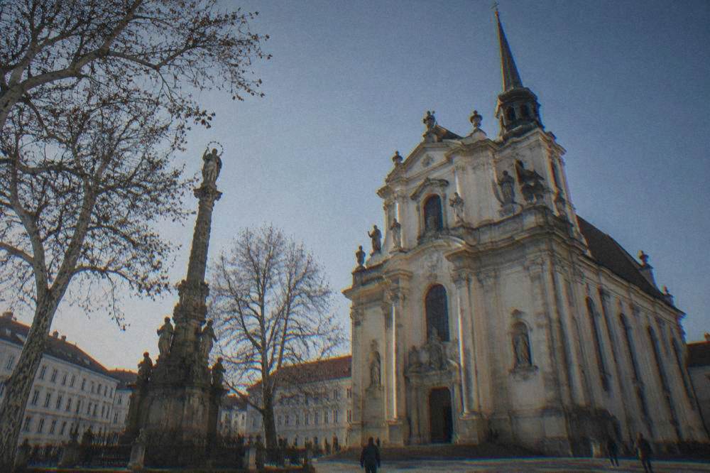 Baroque facade of the Basilica of the Assumption in Old Brno under a clear sky