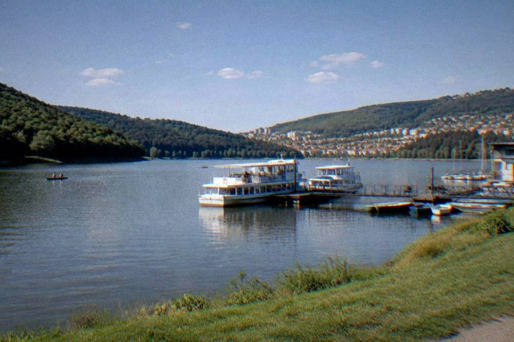 Wooded slopes and calm water of the Brno Reservoir near Bystrc