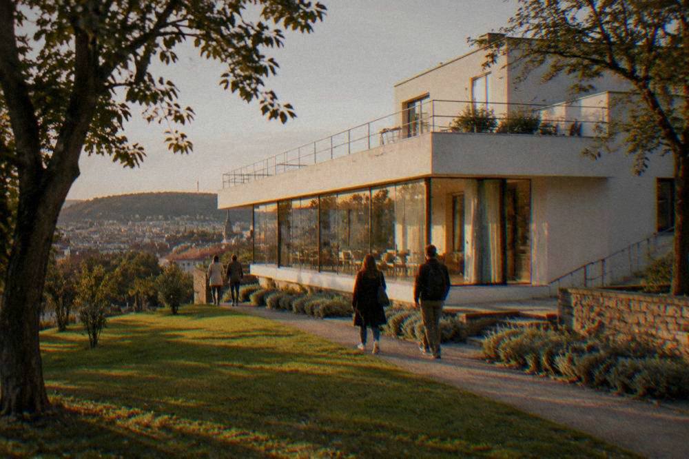Visitors walking past the grand facade of Villa Tugendhat in Brno
