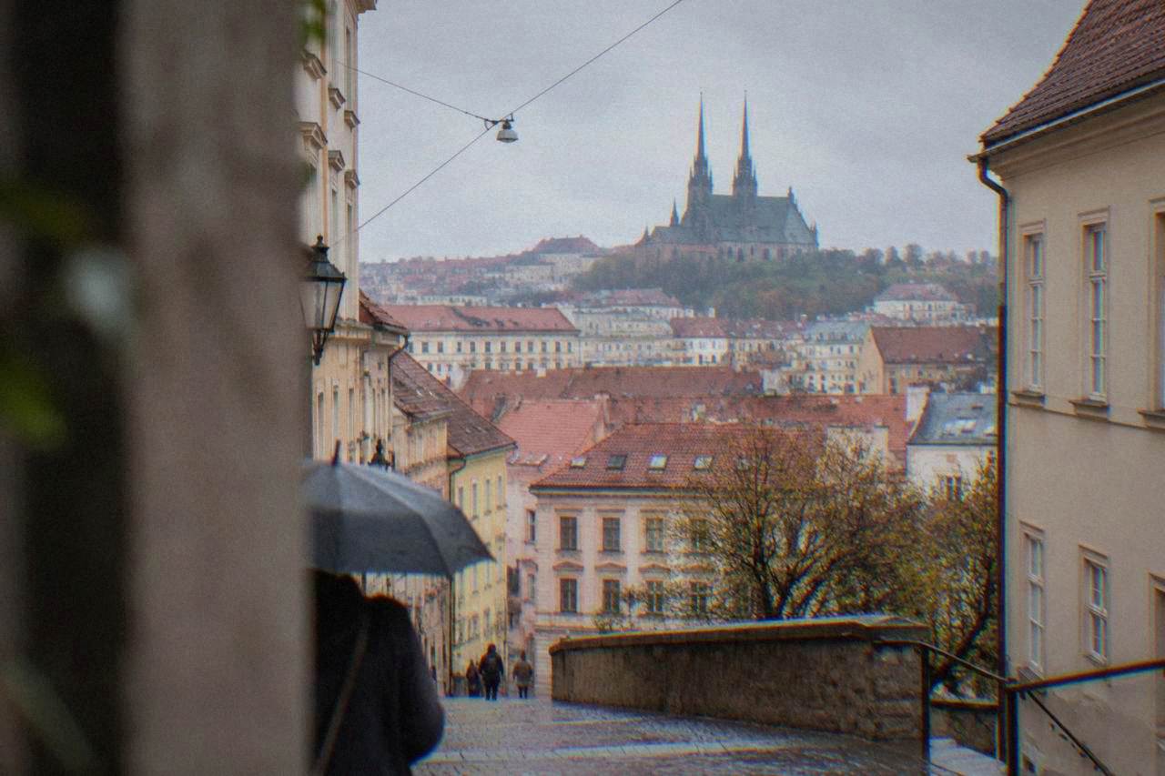 View over the red rooftops of Brno old town toward the twin spires of the cathedral on Petrov Hill