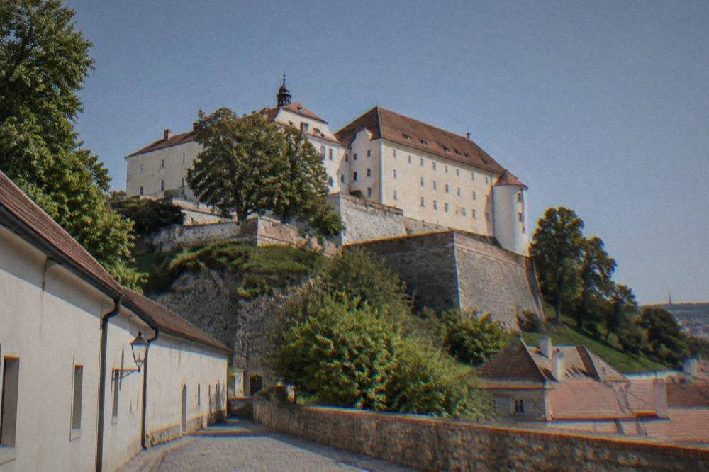 Špilberk Castle walls and courtyard above the city of Brno under a clear sky