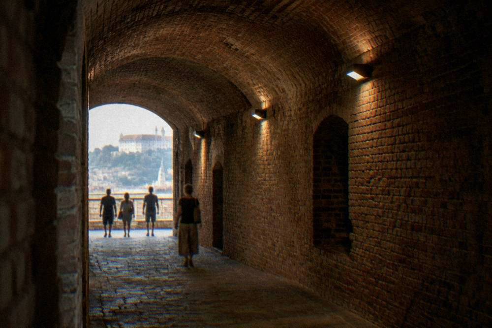 The Casemates corridor inside Špilberk Castle with brick vaulting lit by lamps