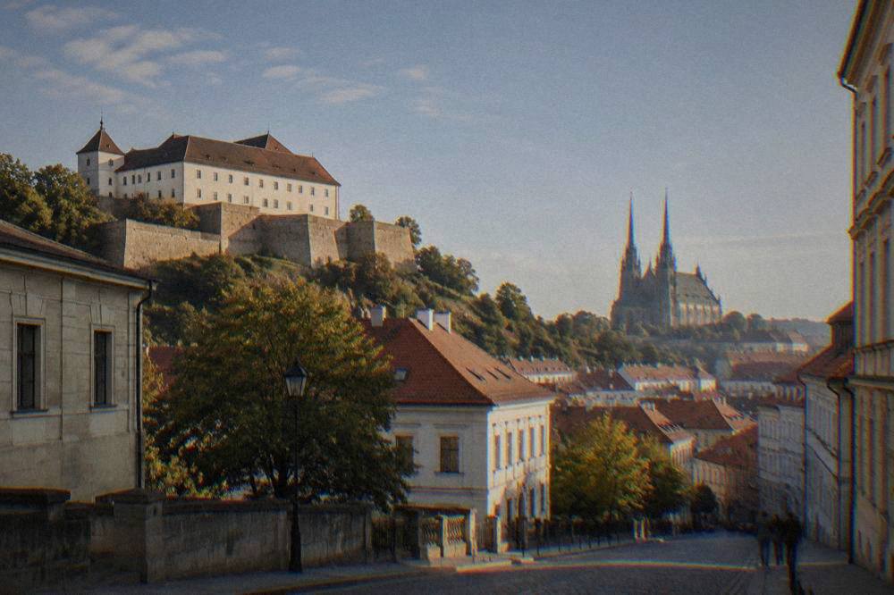 The twin spires of the Cathedral of Sts Peter and Paul seen from a Brno street in morning light