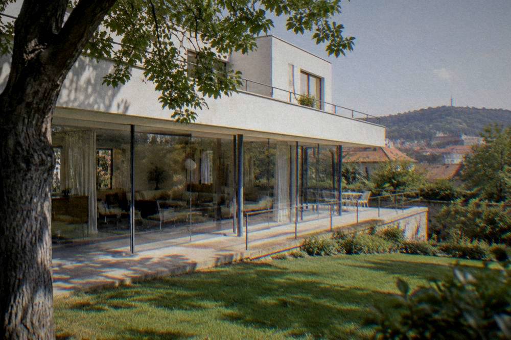 The glass-walled main living space of Villa Tugendhat opening onto its garden terrace