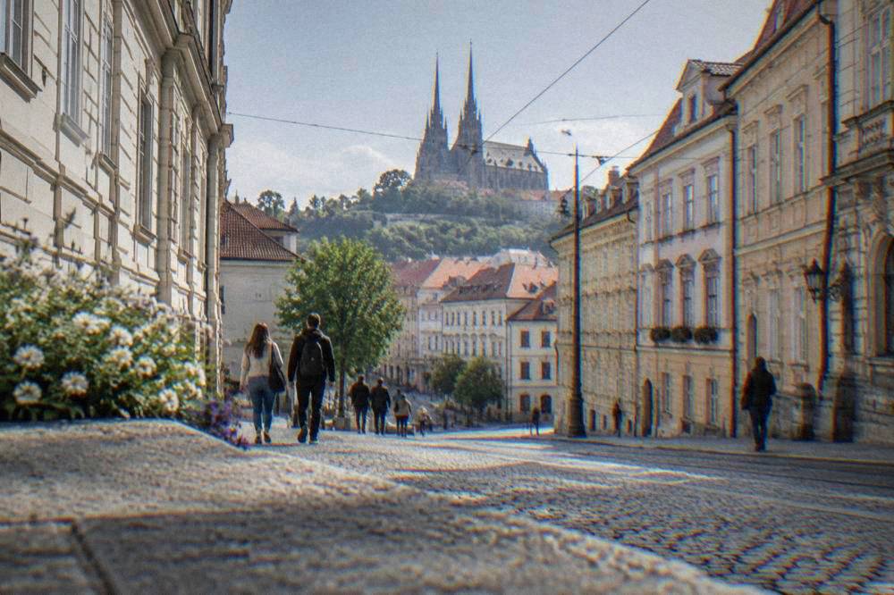 Twin spired cathedral on a hill above red rooftops in Brno