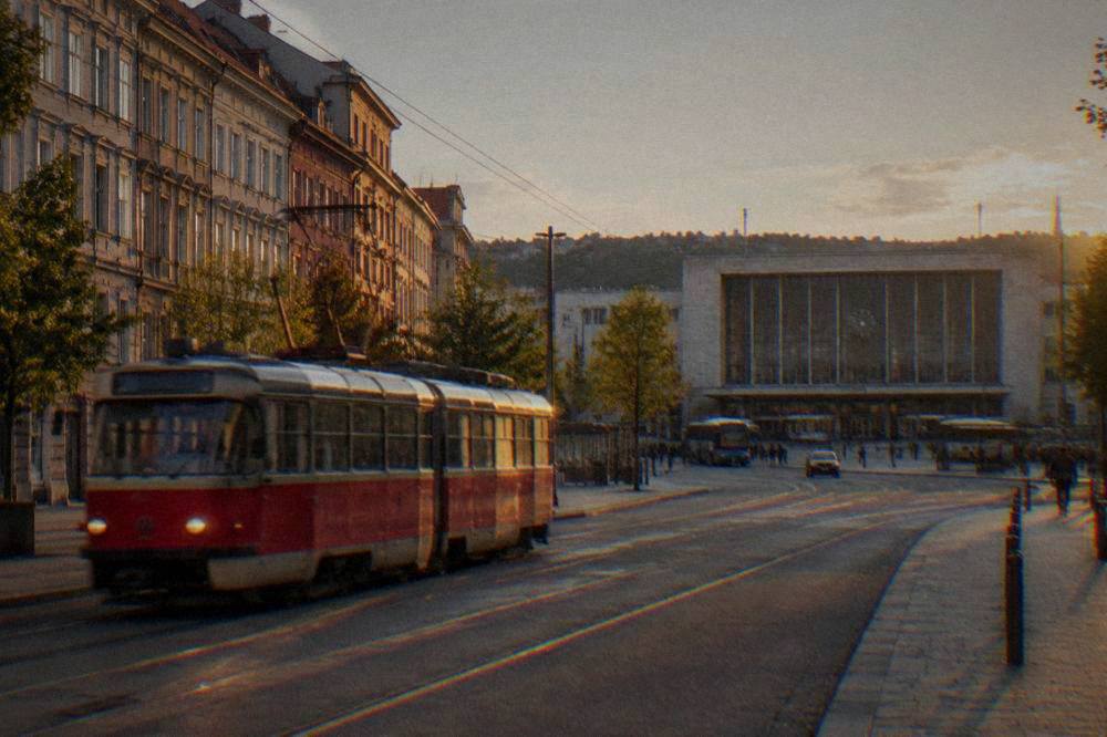 A red tram moving along a street with historic buildings