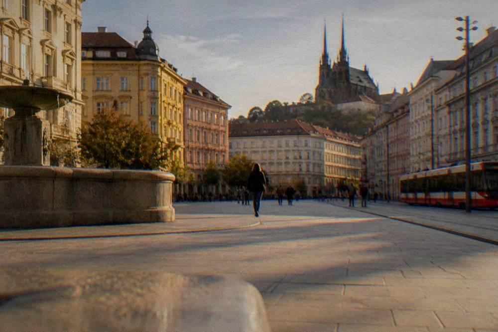 The twin gothic spires of the cathedral on Petrov Hill seen from a Brno street
