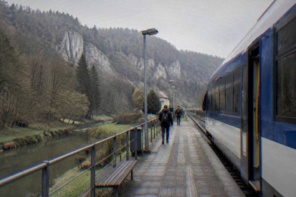 Small town railway station platform with a regional train waiting