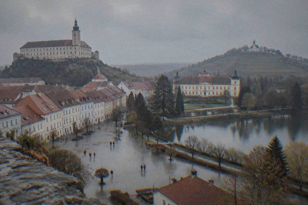 A grand chateau beside a landscaped park with a lake in South Moravia